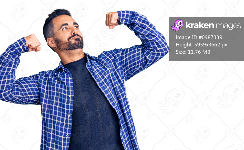 Young hispanic man wearing casual clothes showing arms muscles smiling proud. fitness concept. 