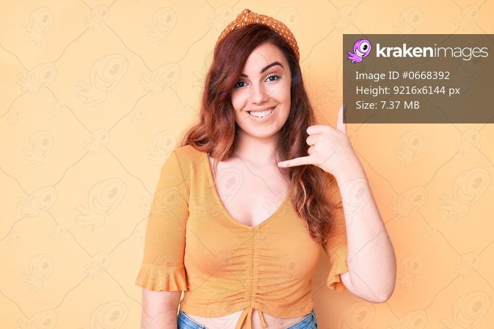 Young beautiful woman wearing casual clothes smiling doing phone gesture with hand and fingers like talking on the telephone. communicating concepts. 