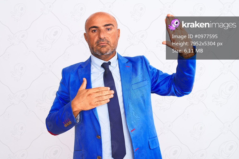 Middle age businessman wearing suit standing over isolated white background Swearing with hand on chest and open palm, making a loyalty promise oath