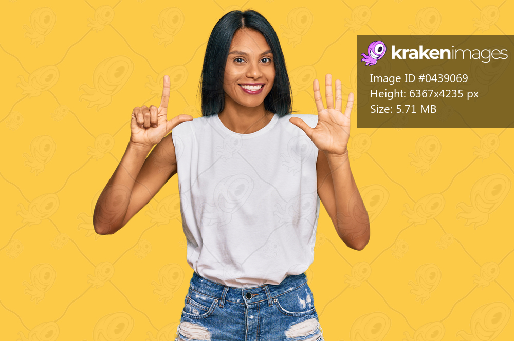 Young african american woman wearing casual clothes showing and pointing up with fingers number seven while smiling confident and happy. 