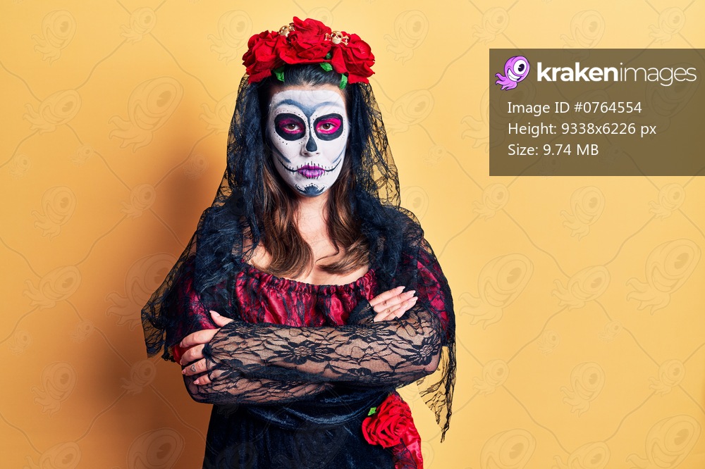 Young woman wearing day of the dead costume over yellow skeptic and nervous, disapproving expression on face with crossed arms. negative person. 