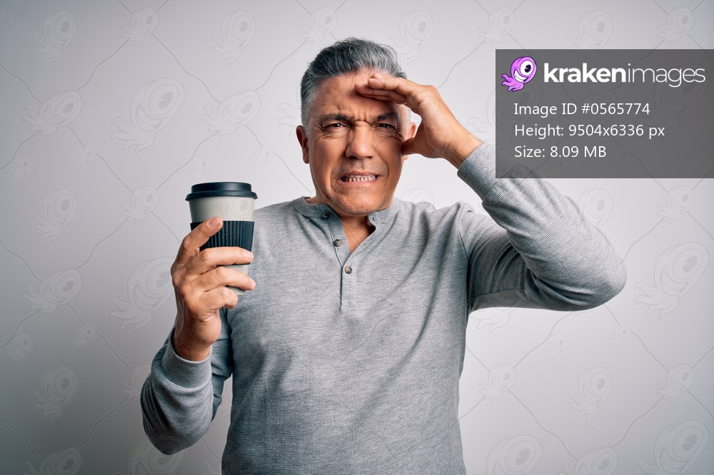 Middle age handsome grey-haired man drinking cup of coffee over isolated white background stressed with hand on head, shocked with shame and surprise face, angry and frustrated. Fear and upset for mistake.