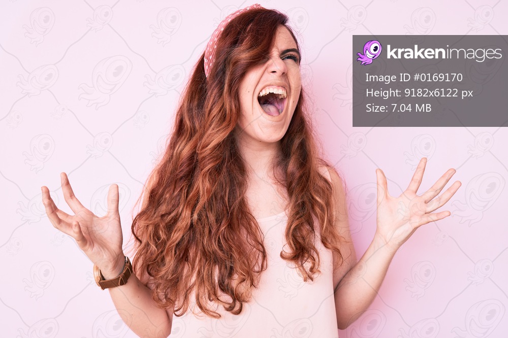 Young beautiful woman wearing casual clothes crazy and mad shouting and yelling with aggressive expression and arms raised. frustration concept. 