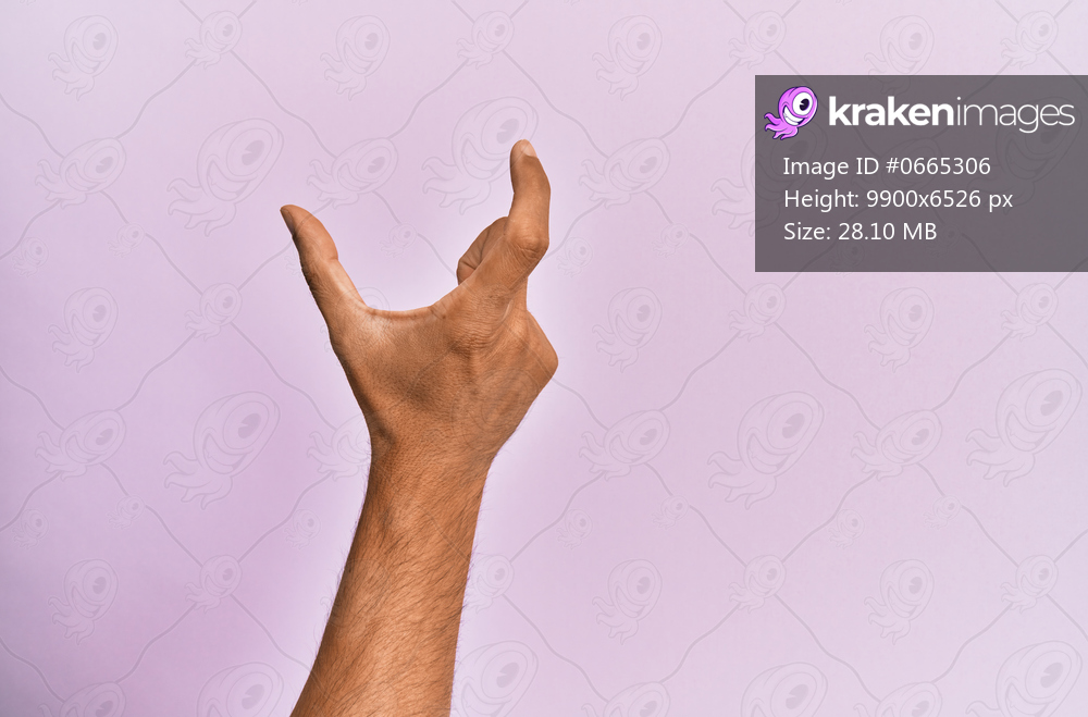 Arm and hand of caucasian young man over pink isolated background picking and taking invisible thing, holding object with fingers showing space 