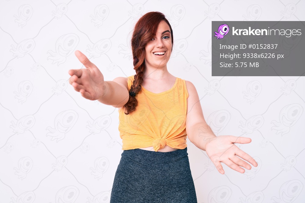 Young beautiful woman wearing casual clothes looking at the camera smiling with open arms for hug. cheerful expression embracing happiness. 