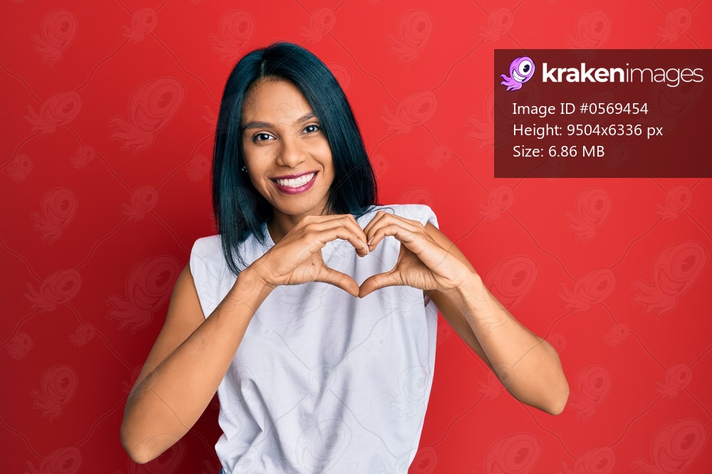 Young african american woman wearing casual clothes smiling in love doing heart symbol shape with hands. romantic concept. 