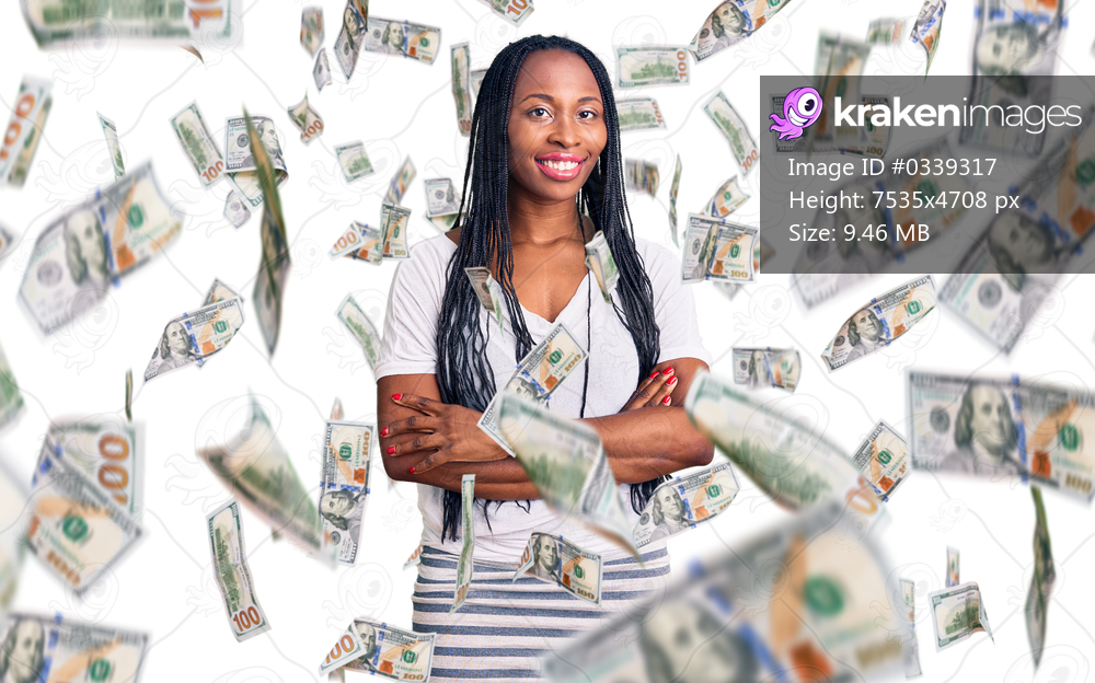 Young african american woman wearing casual clothes happy face smiling with crossed arms looking at the camera. positive person.