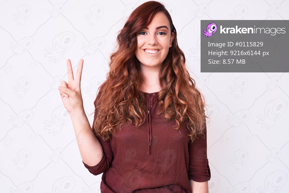 Young beautiful woman wearing casual clothes smiling with happy face winking at the camera doing victory sign. number two. 