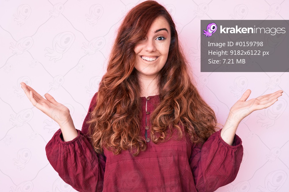 Young beautiful woman wearing casual winter sweater celebrating victory with happy smile and winner expression with raised hands 