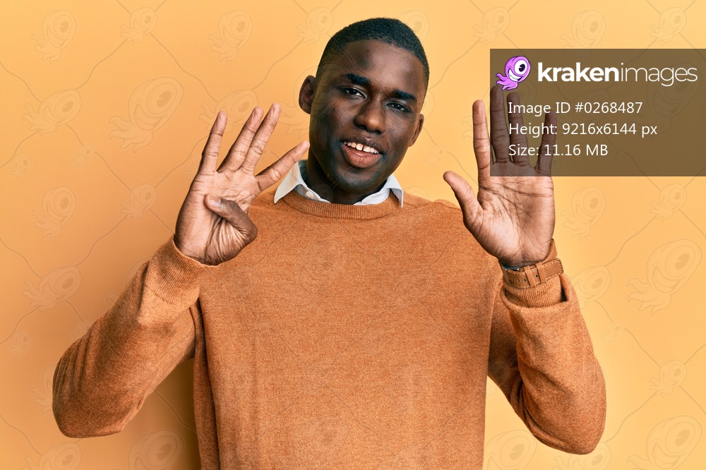 Young african american man wearing casual clothes showing and pointing up with fingers number nine while smiling confident and happy. 