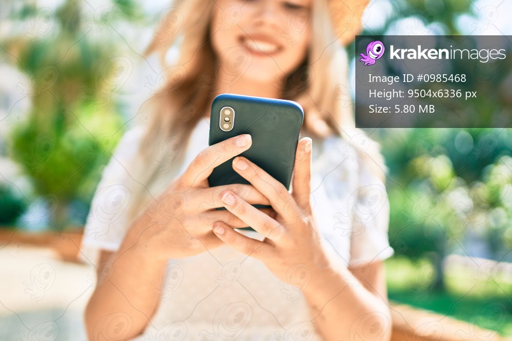 Young caucasian tourist girl smiling happy using smartphone at street of city.