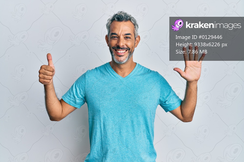 Middle age grey-haired man wearing casual clothes showing and pointing up with fingers number six while smiling confident and happy. 
