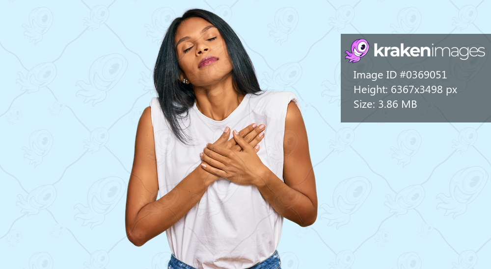 Young african american woman wearing casual clothes smiling with hands on chest with closed eyes and grateful gesture on face. health concept. 