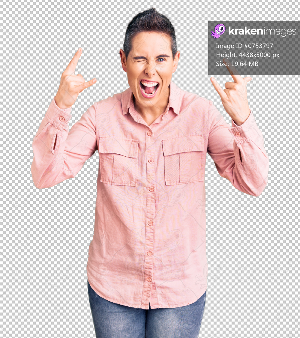 Young woman with short hair wearing casual clothes shouting with crazy expression doing rock symbol with hands up. music star. heavy music concept.