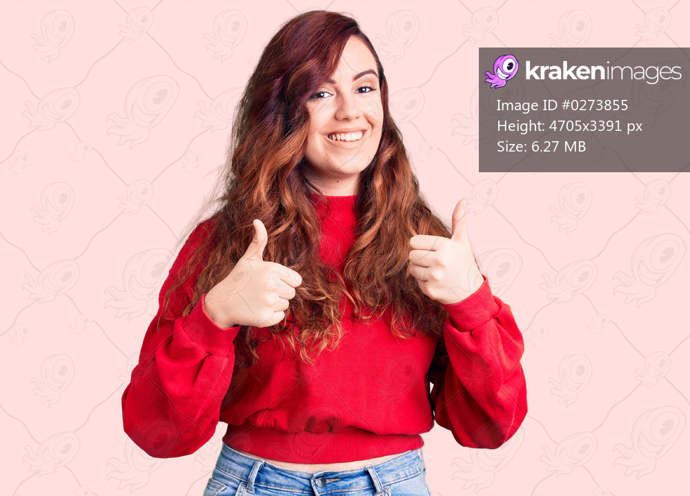 Young beautiful woman wearing casual winter sweater success sign doing positive gesture with hand, thumbs up smiling and happy. cheerful expression and winner gesture. 
