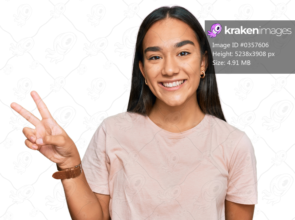 Young asian woman wearing casual clothes showing and pointing up with fingers number two while smiling confident and happy. 