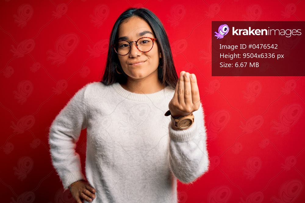 Young beautiful asian woman wearing casual sweater and glasses over red background Doing Italian gesture with hand and fingers confident expression