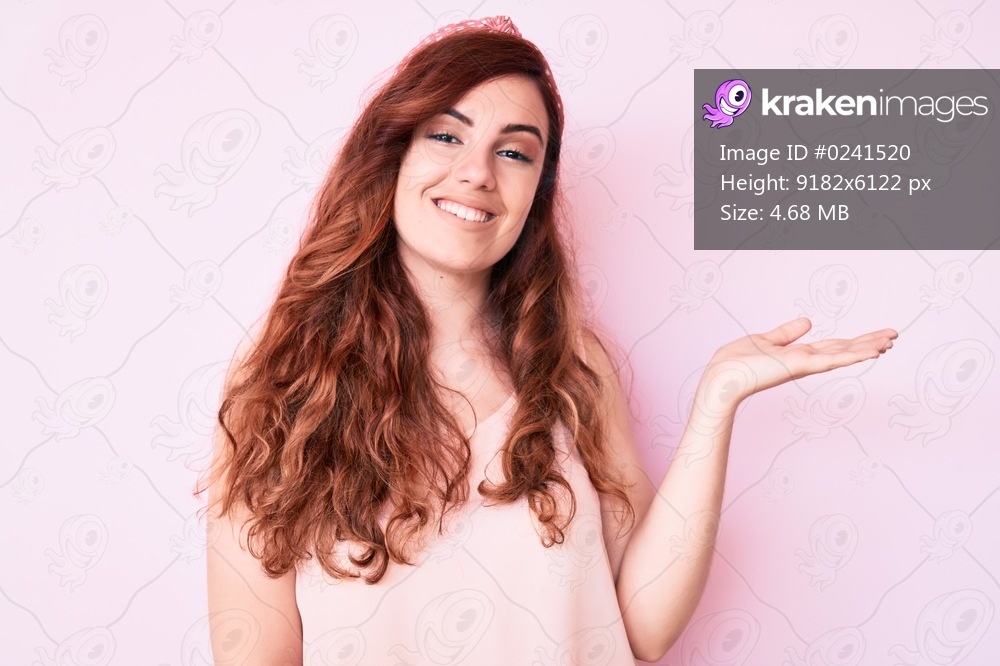 Young beautiful woman wearing casual clothes smiling cheerful presenting and pointing with palm of hand looking at the camera. 