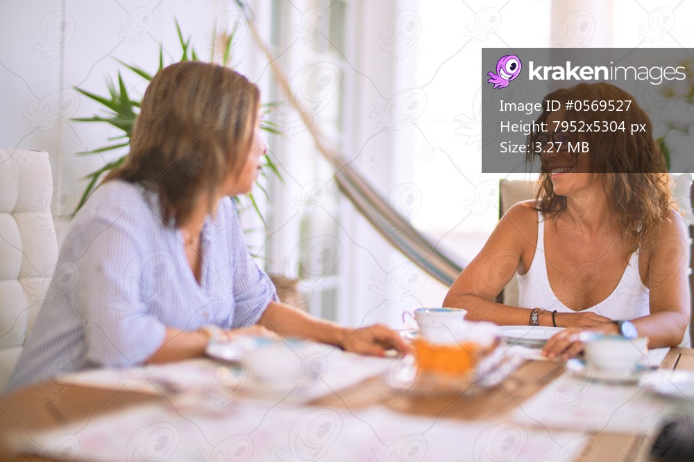 Young beautiful girl smiling happy and confident sitting dinking cup of coffee at terrace