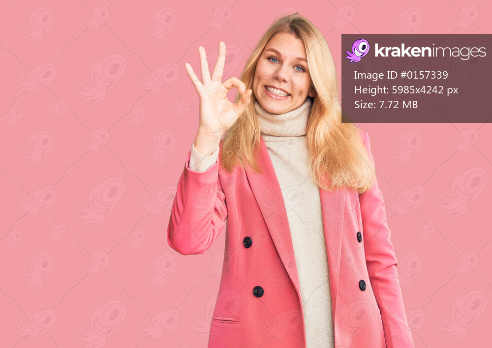 Young beautiful blonde woman wearing elegant clothes smiling positive doing ok sign with hand and fingers. successful expression. 