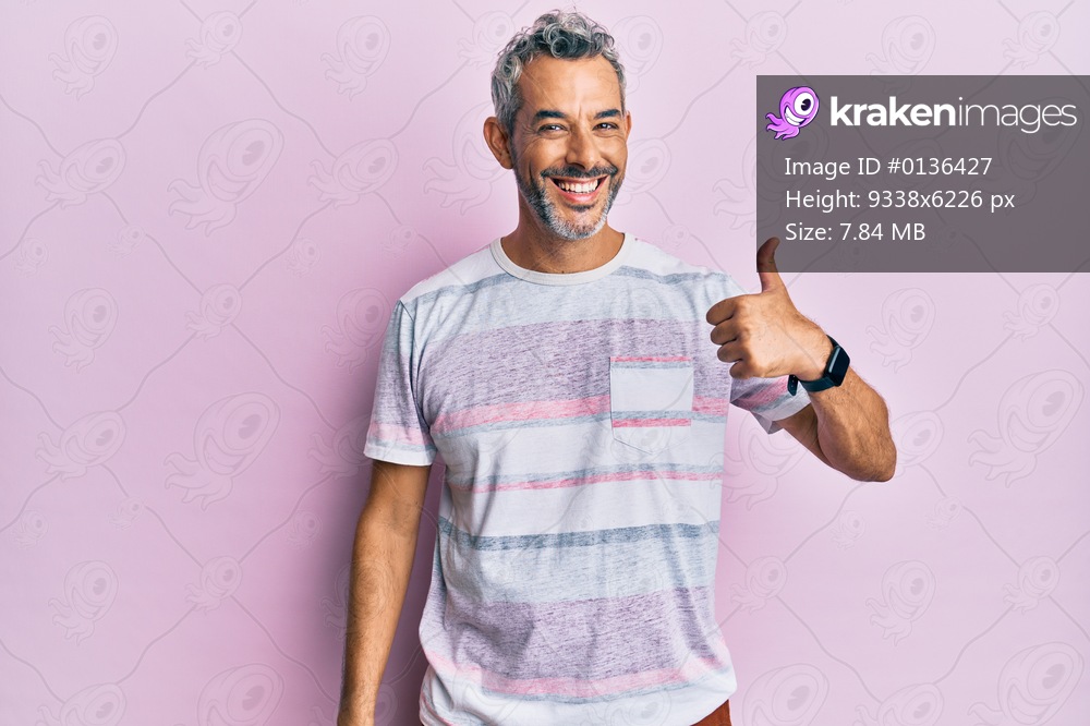 Middle age grey-haired man wearing casual clothes smiling happy and positive, thumb up doing excellent and approval sign 