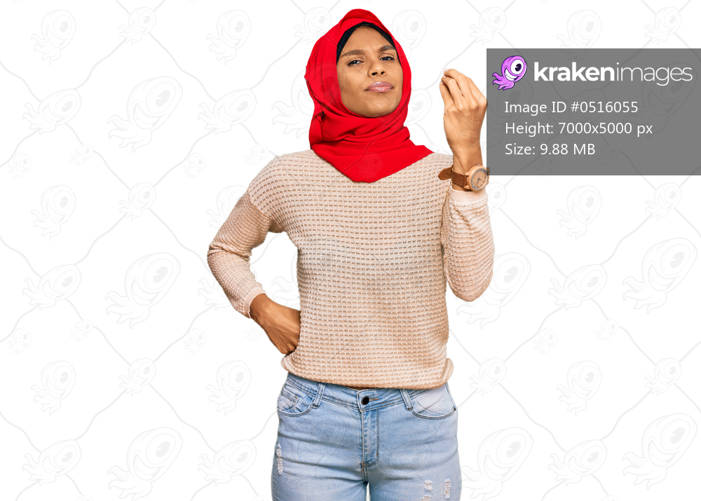 Young african american woman wearing traditional islamic hijab scarf doing italian gesture with hand and fingers confident expression 