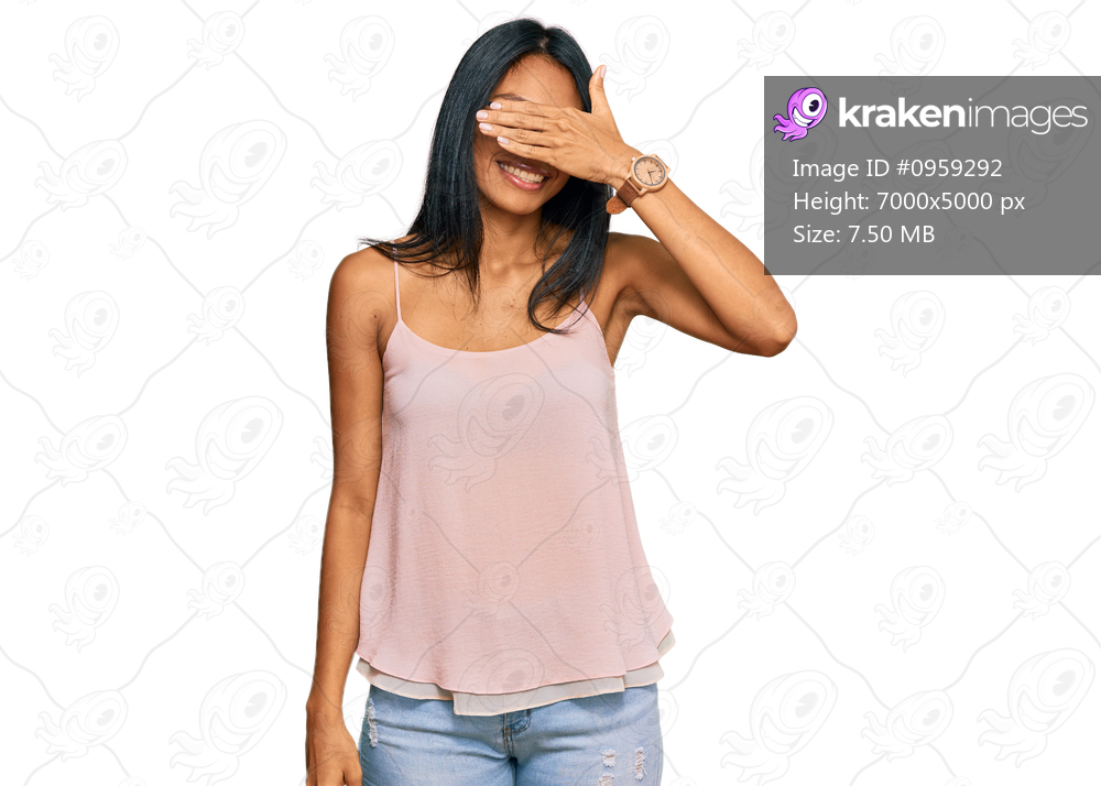Young african american woman wearing casual clothes and glasses smiling and laughing with hand on face covering eyes for surprise. blind concept. 