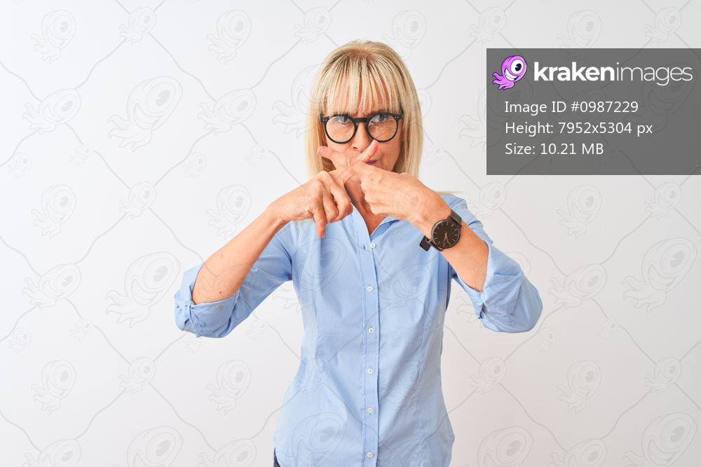 Middle age businesswoman wearing elegant shirt and glasses over isolated white background Rejection expression crossing fingers doing negative sign