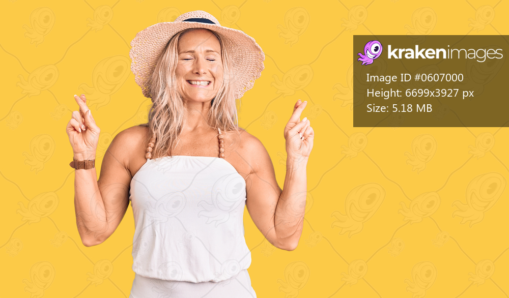 Middle age fit blonde woman wearing summer hat gesturing finger crossed smiling with hope and eyes closed. luck and superstitious concept. 