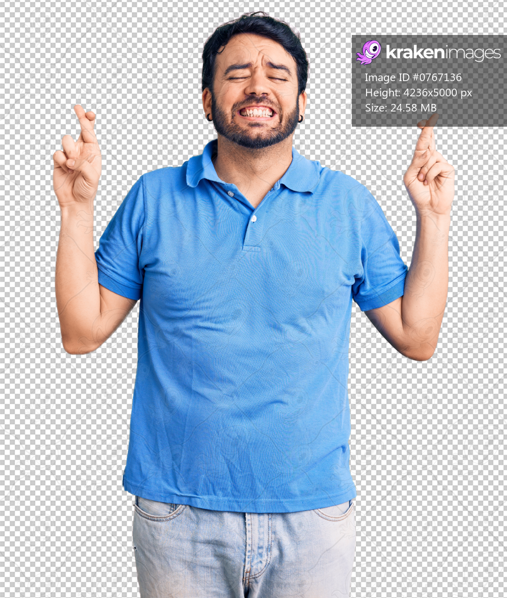 Young hispanic man wearing casual clothes gesturing finger crossed smiling with hope and eyes closed. luck and superstitious concept.