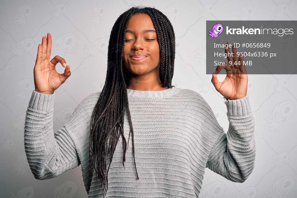 Young african american woman standing casual and cool over grey isolated background relax and smiling with eyes closed doing meditation gesture with fingers. Yoga concept.