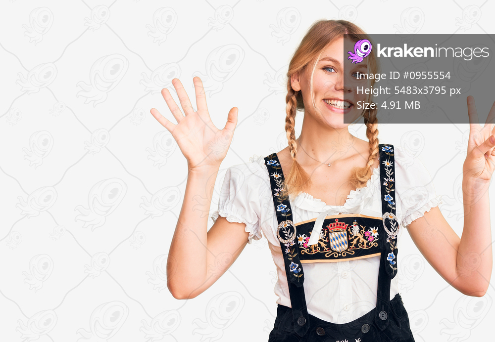 Young beautiful blonde woman wearing oktoberfest dress showing and pointing up with fingers number eight while smiling confident and happy. 