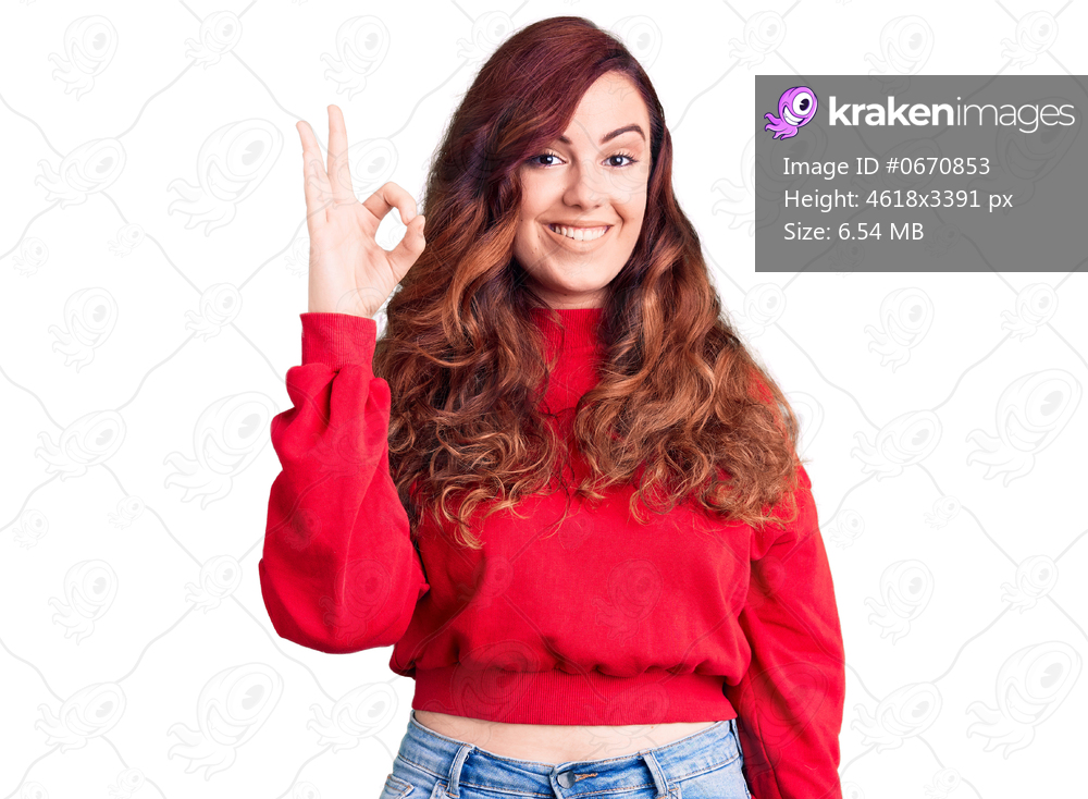 Young beautiful woman wearing casual winter sweater smiling positive doing ok sign with hand and fingers. successful expression. 