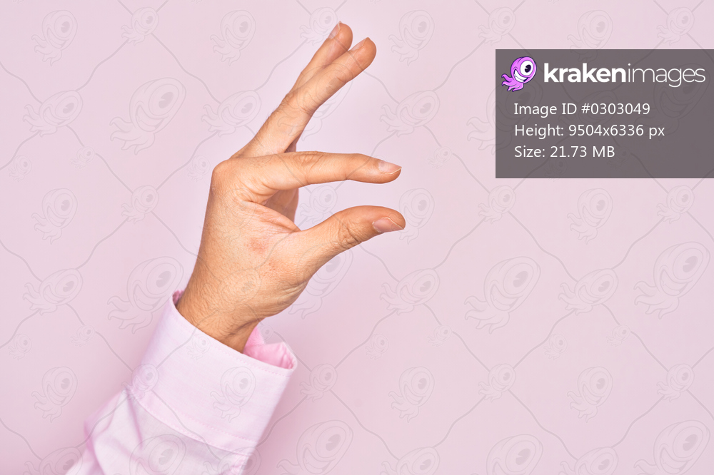 Hand of caucasian young man showing fingers over isolated pink background picking and taking invisible thing, holding object with fingers showing space