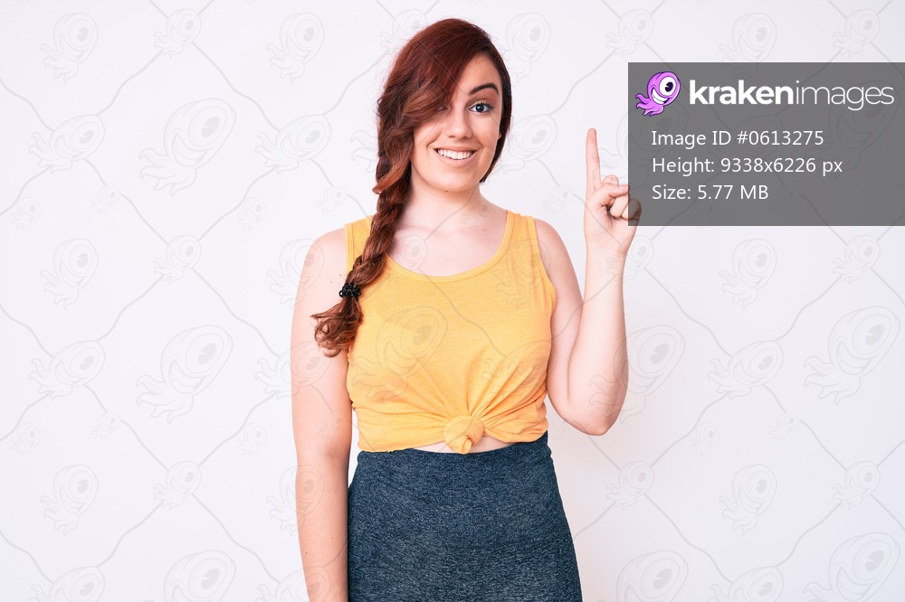 Young beautiful woman wearing casual clothes smiling with an idea or question pointing finger up with happy face, number one 