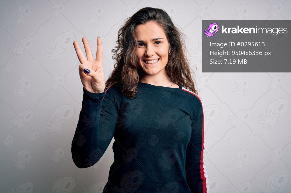Young beautiful woman with curly hair wearing casual sweater over isolated white background showing and pointing up with fingers number three while smiling confident and happy.