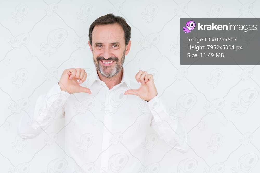 Elegant senior man over isolated background looking confident with smile on face, pointing oneself with fingers proud and happy.