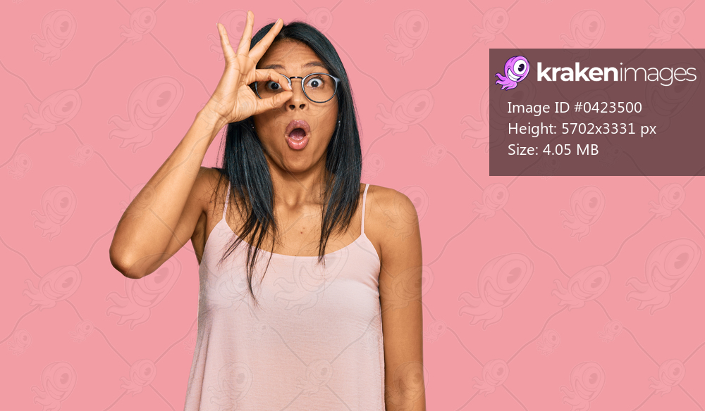 Young african american woman wearing casual clothes and glasses doing ok gesture shocked with surprised face, eye looking through fingers. unbelieving expression. 