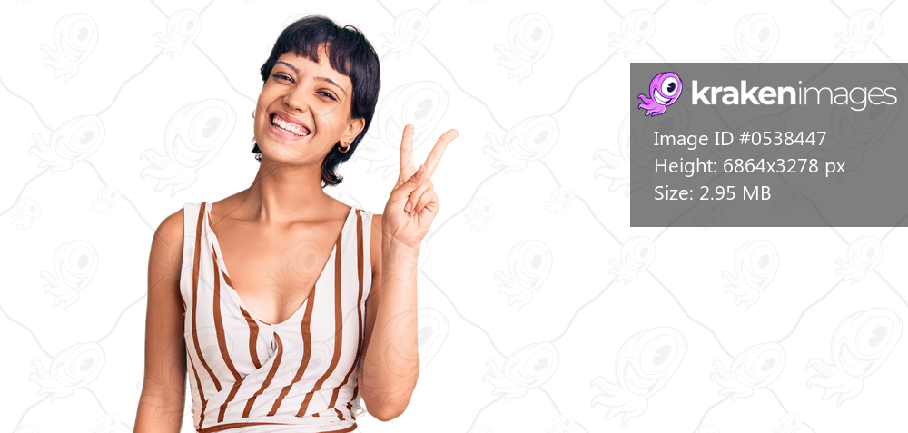 Young brunette woman with short hair wearing summer outfit showing and pointing up with fingers number two while smiling confident and happy. 