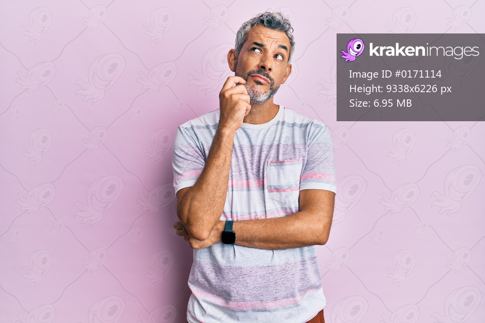 Middle age grey-haired man wearing casual clothes serious face thinking about question with hand on chin, thoughtful about confusing idea 