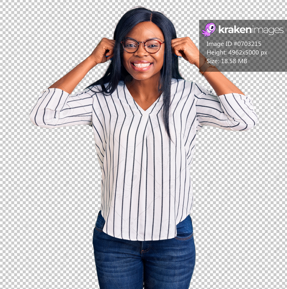 Young african american woman wearing casual clothes and glasses smiling pulling ears with fingers, funny gesture. audition problem