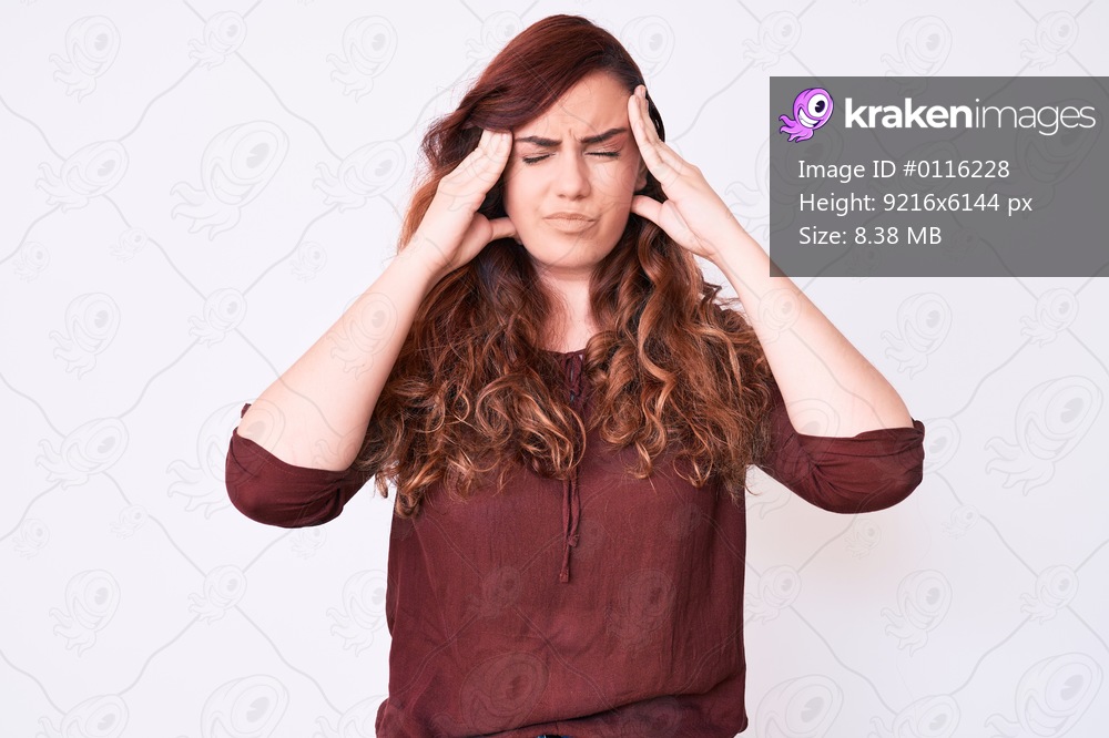 Young beautiful woman wearing casual clothes suffering from headache desperate and stressed because pain and migraine. hands on head. 