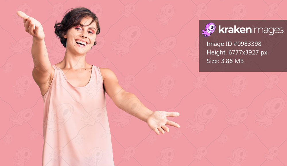 Beautiful young woman with short hair wearing casual style with sleeveless shirt looking at the camera smiling with open arms for hug. cheerful expression embracing happiness. 