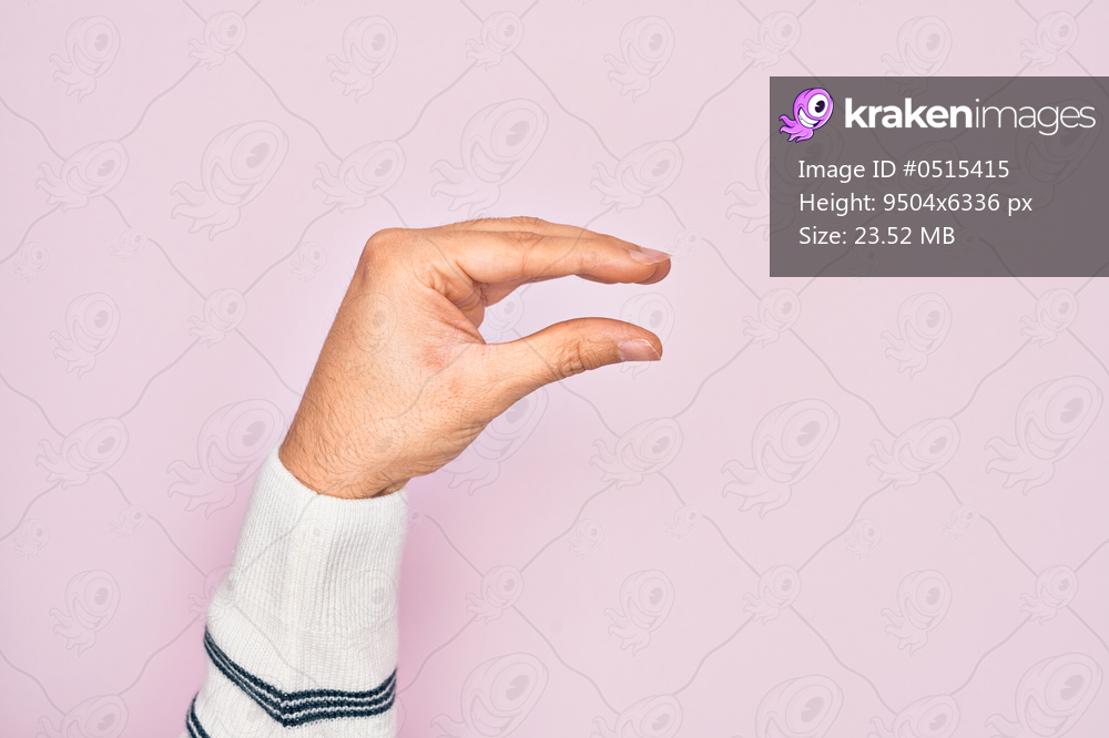 Hand of caucasian young man showing fingers over isolated pink background picking and taking invisible thing, holding object with fingers showing space