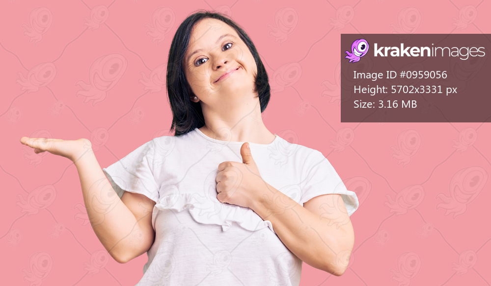 Brunette woman with down syndrome wearing casual white tshirt showing palm hand and doing ok gesture with thumbs up, smiling happy and cheerful 