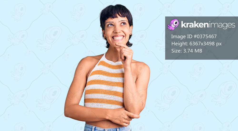 Young brunette woman with short hair wearing casual clothes looking confident at the camera smiling with crossed arms and hand raised on chin. thinking positive. 