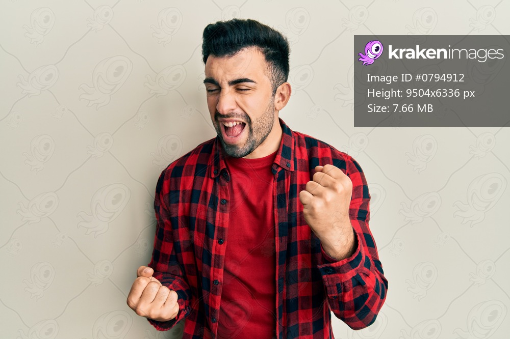 Young hispanic man wearing casual clothes celebrating surprised and amazed for success with arms raised and eyes closed 