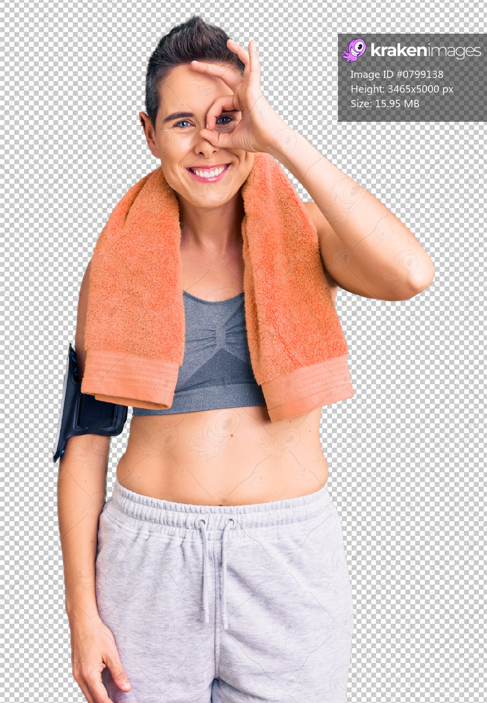 Young woman with short hair wearing sportswear and towel using smartphone doing ok gesture with hand smiling, eye looking through fingers with happy face.