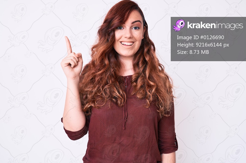 Young beautiful woman wearing casual clothes pointing finger up with successful idea. exited and happy. number one. 