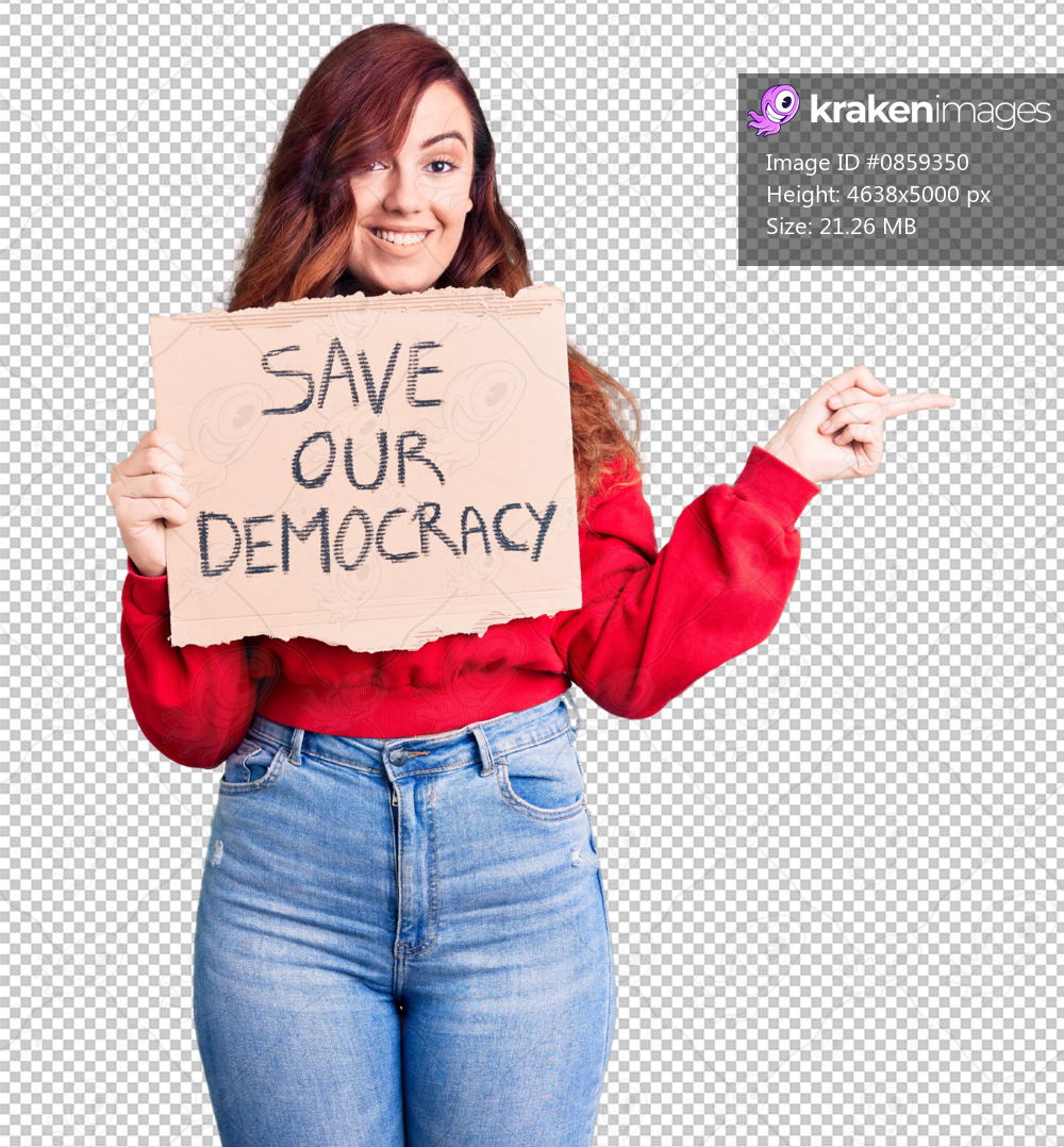 Young beautiful woman holding save our democracy protest banner smiling happy pointing with hand and finger to the side
